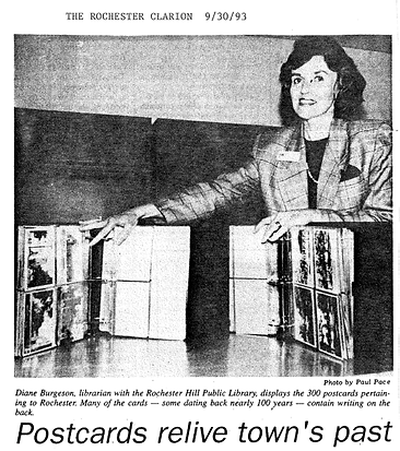 Newspaper clipping from the Rocehster Clarion from September, 30 1993, with a photo of a librarian displaying photo books full of post cards. The caption reads "Photo image caption: "Diane Burgeson, librarian with the Rochester Hill[s] Public Library, displays the 300 postcards pertaining to Rochester. Many of the cards - some dating back nearly 100 years - contain writing on the back."