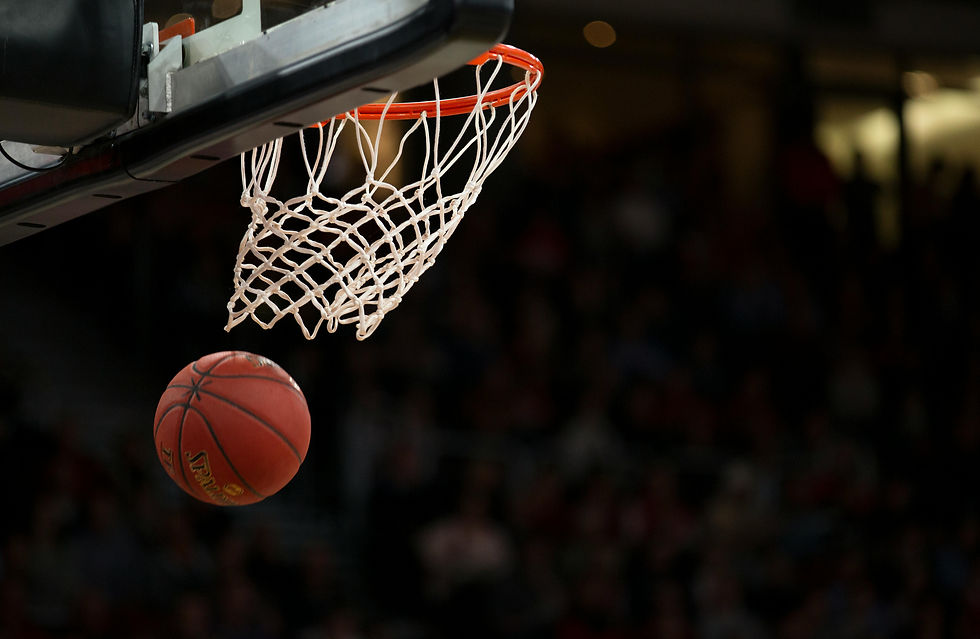 A basketball is pictured in mid-air after flying through the hoop and net.
