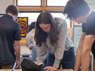 Two groups of teens work on various projects