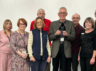 A group of people standing together and smiling - the Friends of RHPL at their annual meeting
