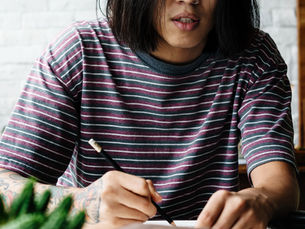 A person writes in a journal