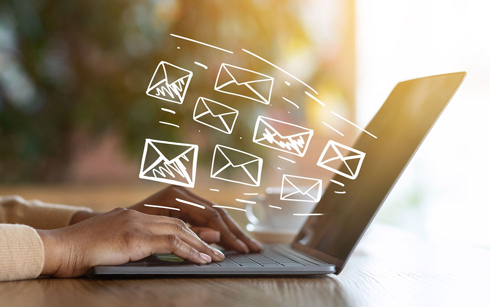 An image of a person typing on a laptop. Drawings of envelopes are drawn over the image to look like they are coming out of the screen.
