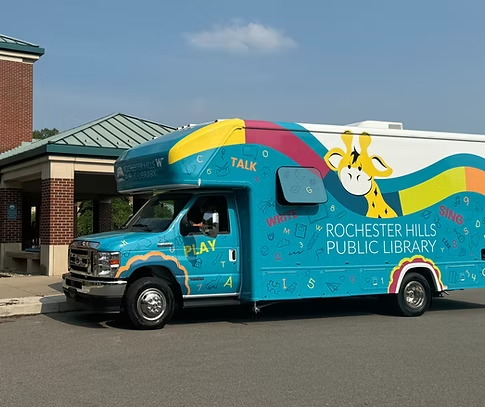 A photograph of the Blue Bus - the RHPL early literacy bookmobile