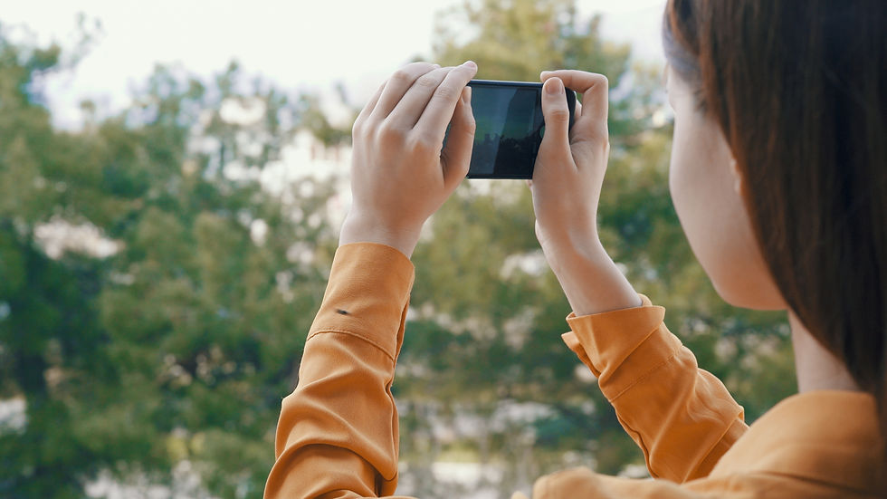 A woman takes a panoramic image with a phone