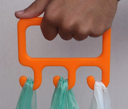 A 3D printed device that has three hooks with shopping bags hanging down