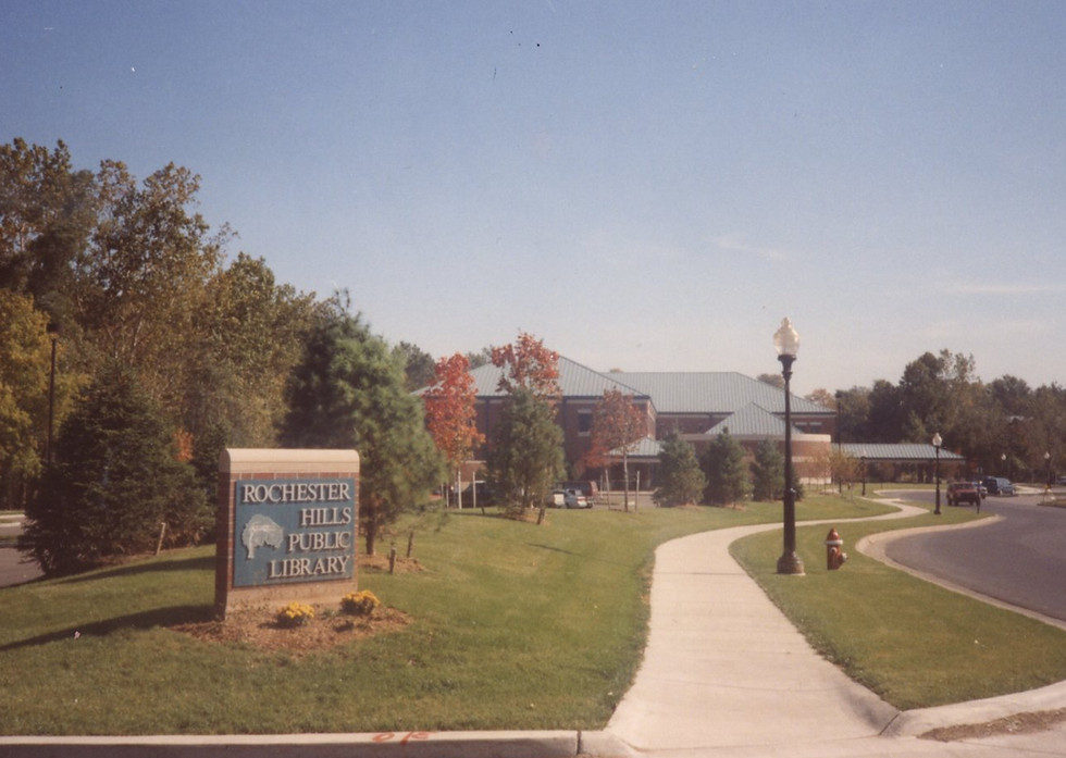A sign at theparking lot entrance reads "Rochester Hills Public Library" and features a logo from when the library was first built.