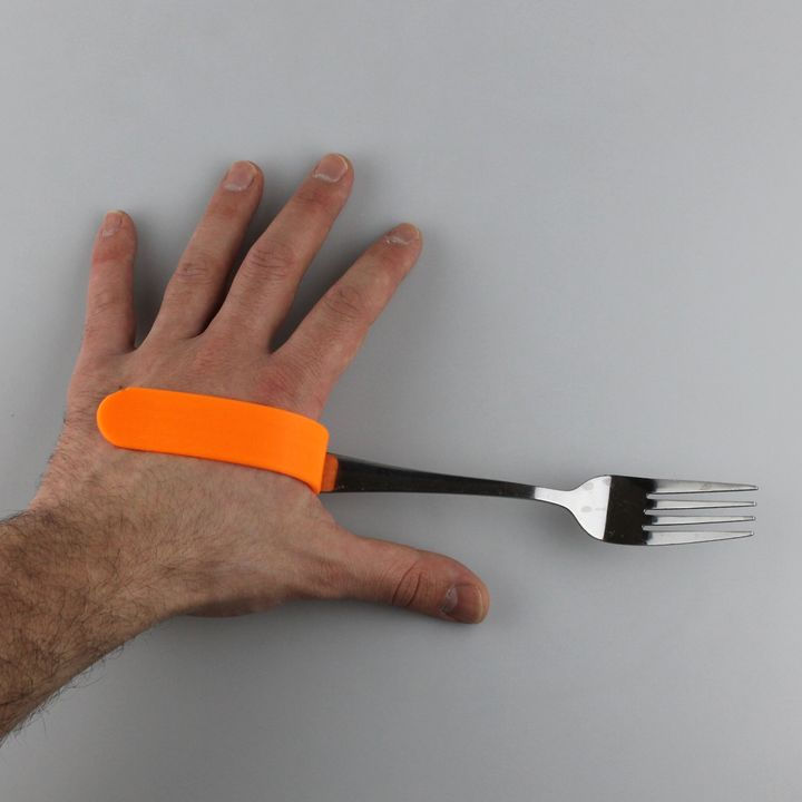 A 3D printed aid that can hold forks and spoons to assist people with disabilities